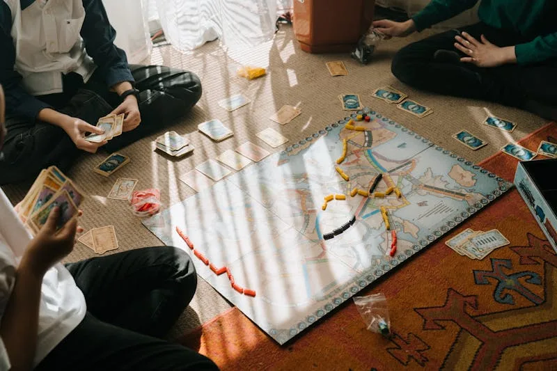 Board game pieces, cards, and dice arranged on a gaming table surface